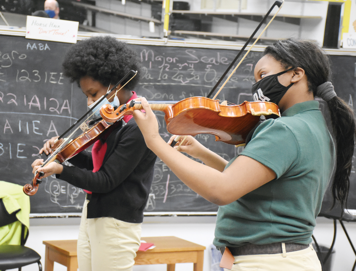 Students at Sister Thea Bowman School practice violin, which is a standard part of every student’s curriculum. (Photo/Linda Behrens)
