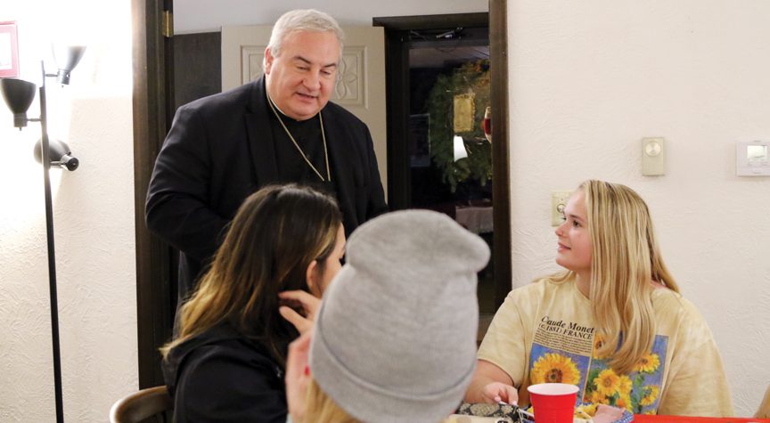 Bishop Michael McGovern visits with students at Joseph House in Lebanon.